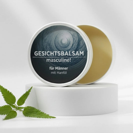 Gesichtsbalsam mit natürlichen Inhaltsstoffen für Männer mit Brennnesselöl, Gesichtsbalsam ist in weißem, zylindrischem Karton verpackt mit rotem Etikett.