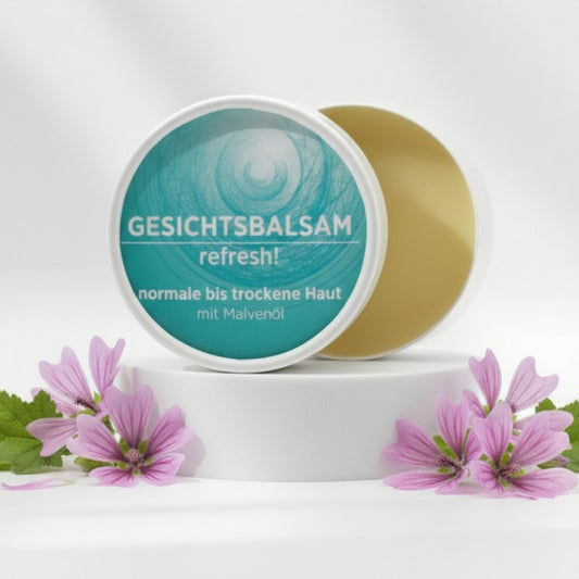Gesichtsbalsam mit natürlichen Inhaltsstoffen bei trockener Haut mit Malvenöl, Gesichtsbalsam ist in weißem, zylindrischem Karton verpackt mit türkisem Etikett.