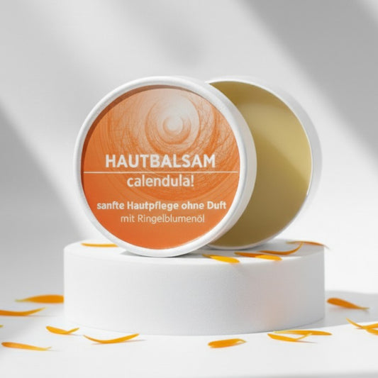 Ringelblumenbalsam mit natürlichen Inhaltsstoffen für empfindliche Haut, Körperbalsam ist in weißem, zylindrischem Karton verpackt mit orangem Etikett.