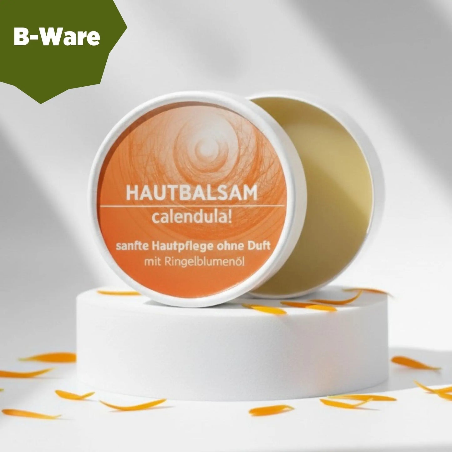 Ringelblumenbalsam mit natürlichen Inhaltsstoffen für empfindliche Haut, Körperbalsam ist in weißem, zylindrischem Karton verpackt mit orangem Etikett. B-Ware.