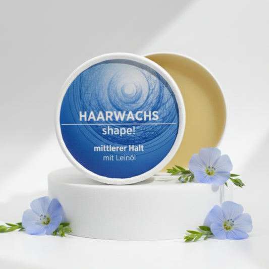 Haarwachs mit natürlichen Inhaltsstoffen für mittleren Halt mit Leinöl, Gesichtsbalsam ist in weißem, zylindrischem Karton verpackt mit blauem Etikett.